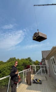 We are using a crane to lift a hot tub off a second story deck in Toronto.